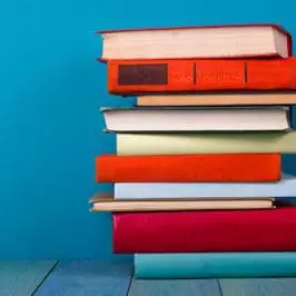 pile of books against blue background i stock