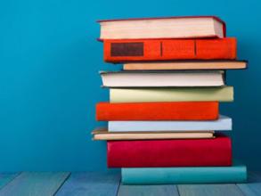 pile of books against blue background i stock